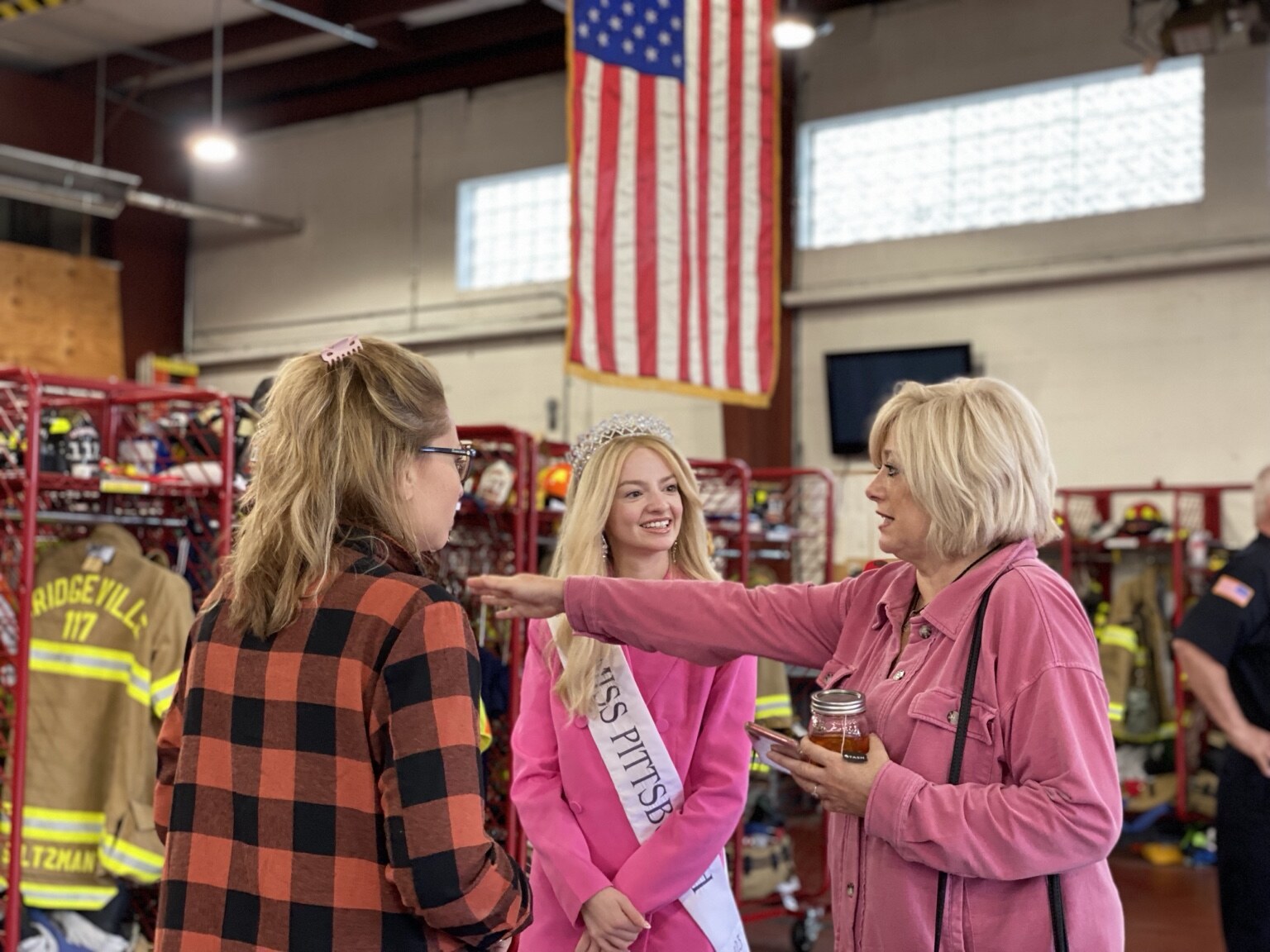 Madison Campbell speaking with guests during a fire station visit