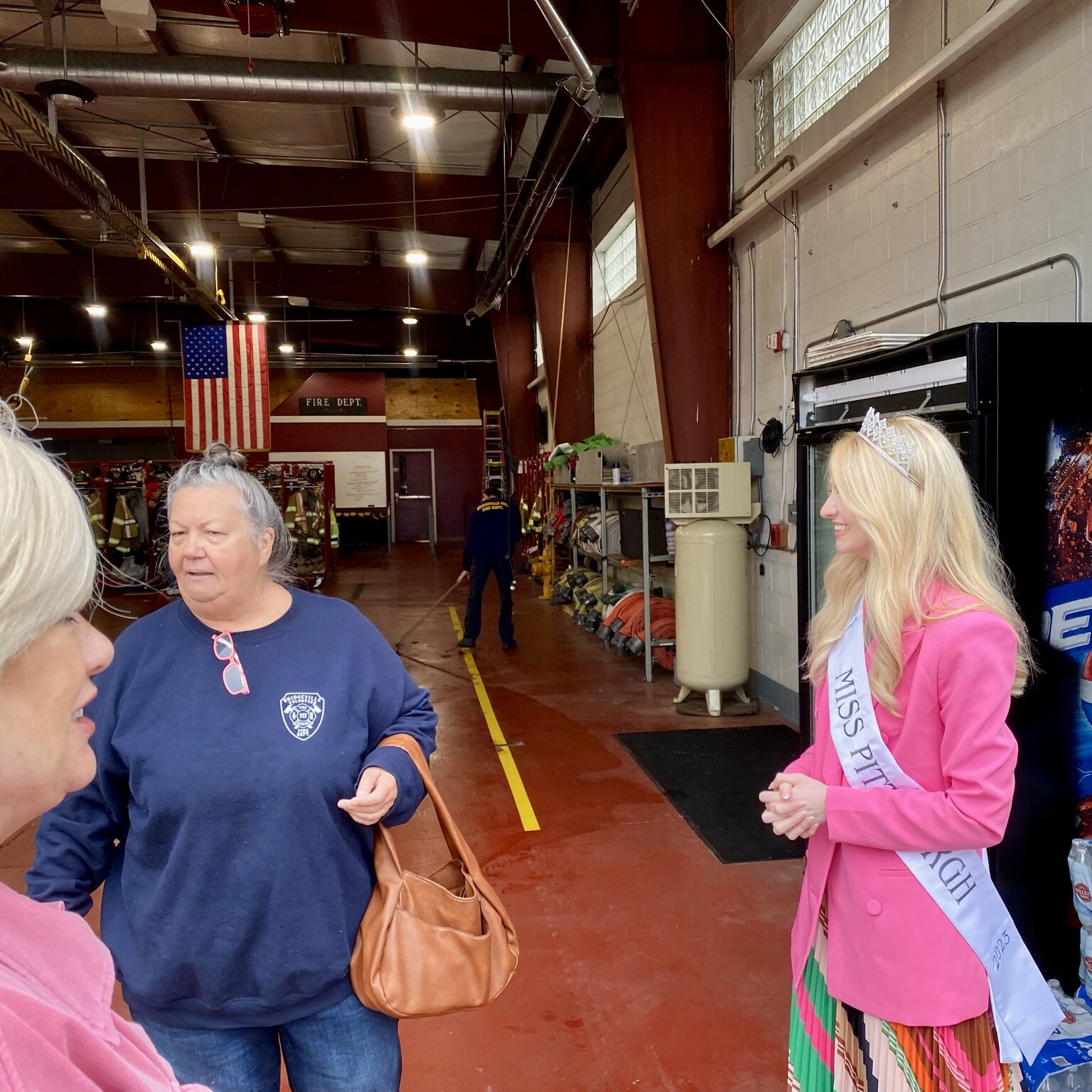 Madison Campbell visiting a fire station in a pink blazer