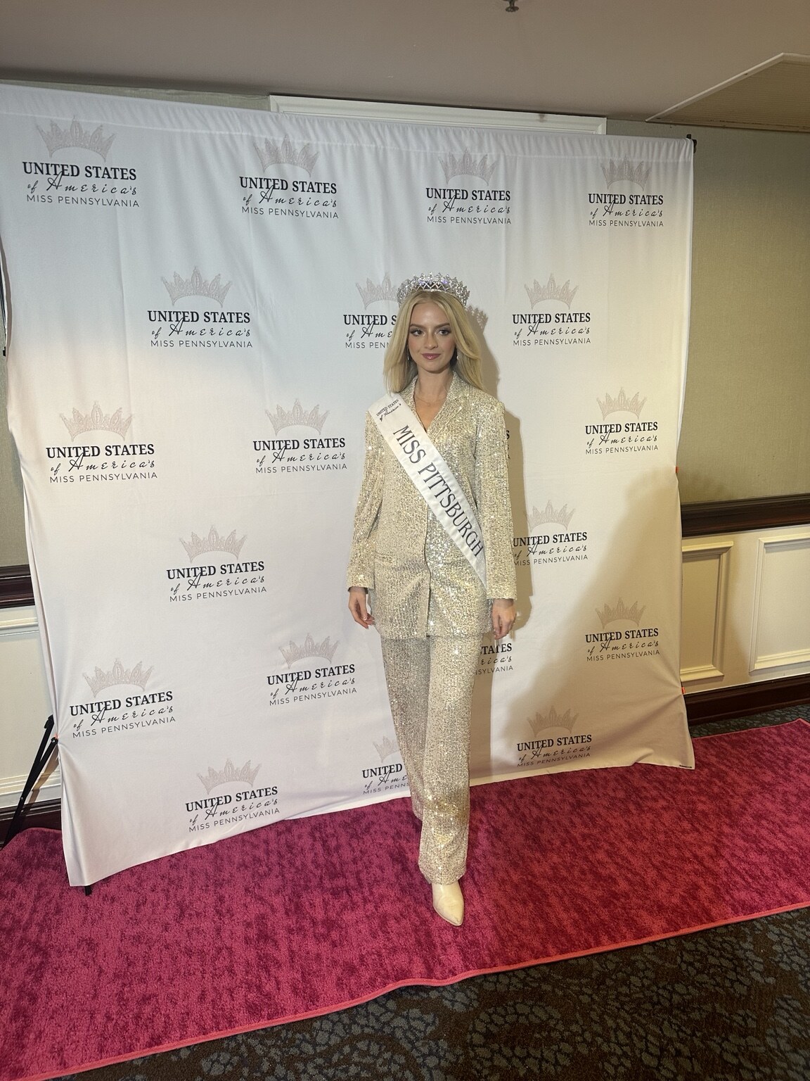Madison Campbell wearing a crown and sash at a pageant event