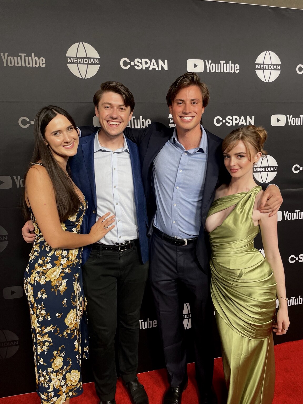 Madison Campbell in a green gown with guests at a White House Correspondents’ Association event